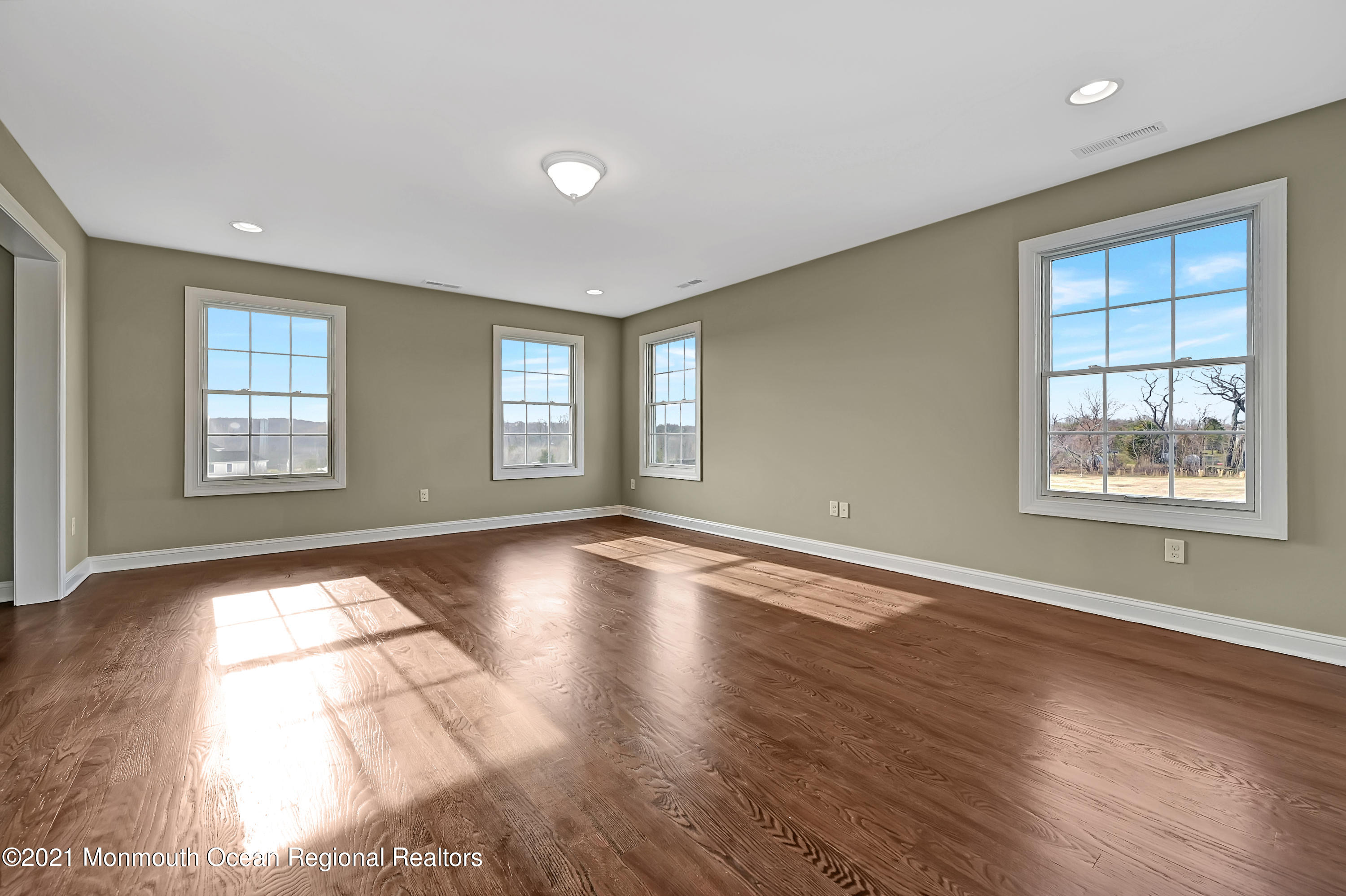 3 Cook Court Millstone Township, NJ 08535 - Photo 26 of 40 a view of an empty room with wooden floor and window