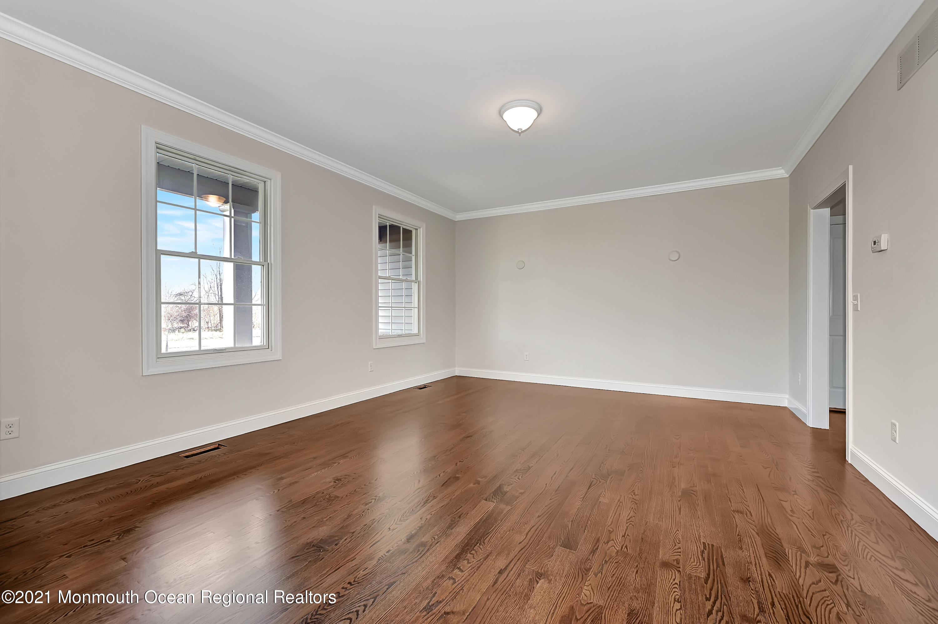 3 Cook Court Millstone Township, NJ 08535 - Photo 4 of 40 an empty room with wooden floor and windows