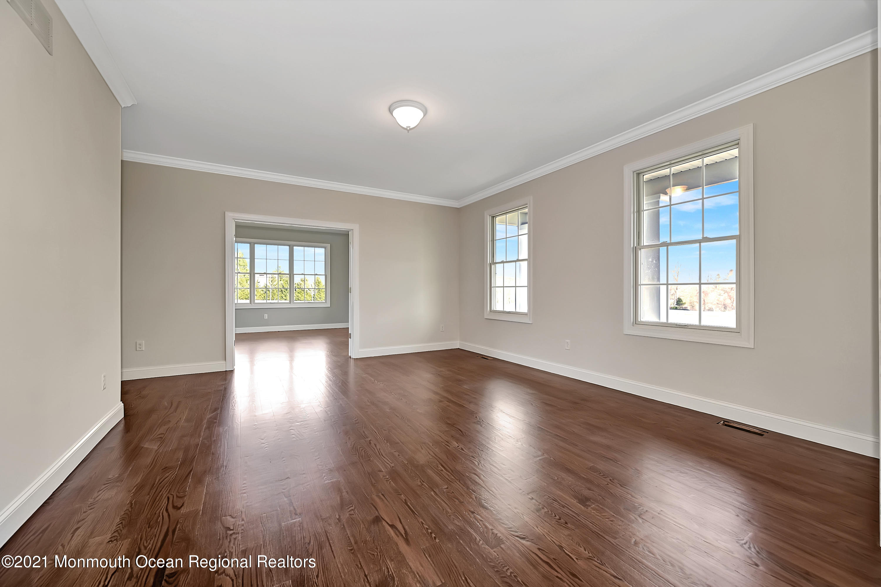 3 Cook Court Millstone Township, NJ 08535 - Photo 6 of 40 a view of an empty room with wooden floor and windows