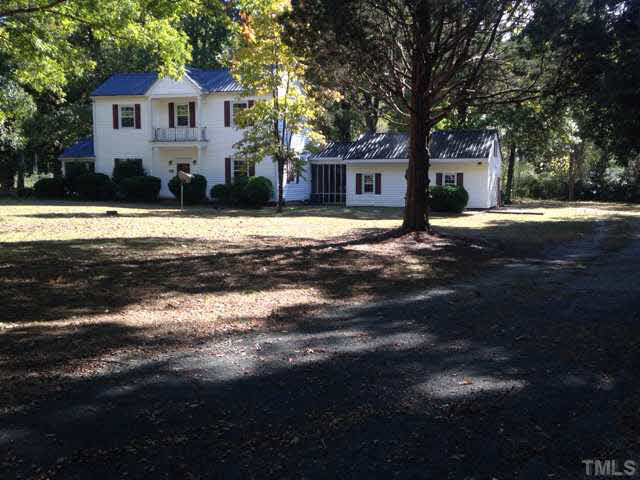 1569 Longs Store Road Roxboro, NC 27574 - Photo 1 of 22 a front view of a house with a yard