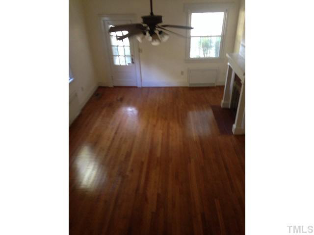 1569 Longs Store Road Roxboro, NC 27574 - Photo 15 of 22 a view of an empty room with wooden floor and a window