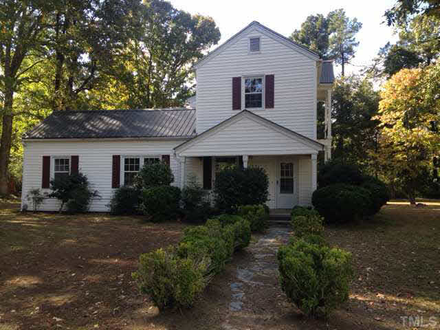 1569 Longs Store Road Roxboro, NC 27574 - Photo 3 of 22 a front view of a house with a garden