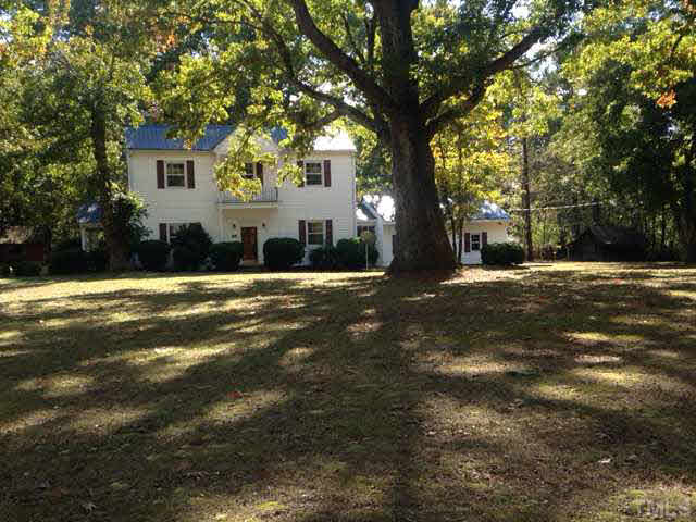 1569 Longs Store Road Roxboro, NC 27574 - Photo 22 of 22 a view of a house with a yard