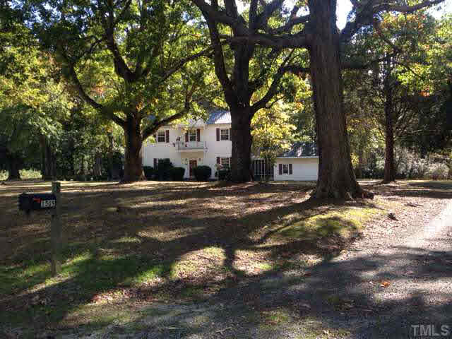 1569 Longs Store Road Roxboro, NC 27574 - Photo 5 of 22 a view of a tree in the middle of a yard