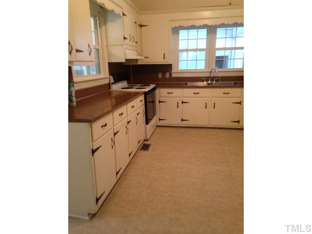 1569 Longs Store Road Roxboro, NC 27574 - Photo 10 of 22 a kitchen with stainless steel appliances granite countertop a sink and a stove