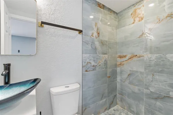 a bathroom with a shower and a toilet