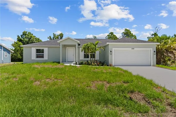 a front view of house with yard and green space