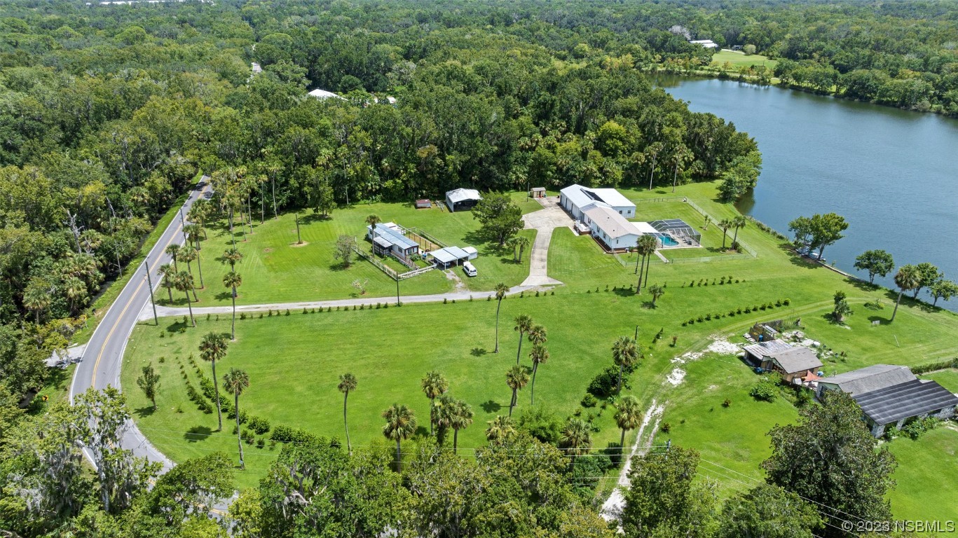 2422 South Taylor Road New Smyrna Beach, FL 32168 - Photo 11 of 19 an aerial view of a residential houses with outdoor space and lake view