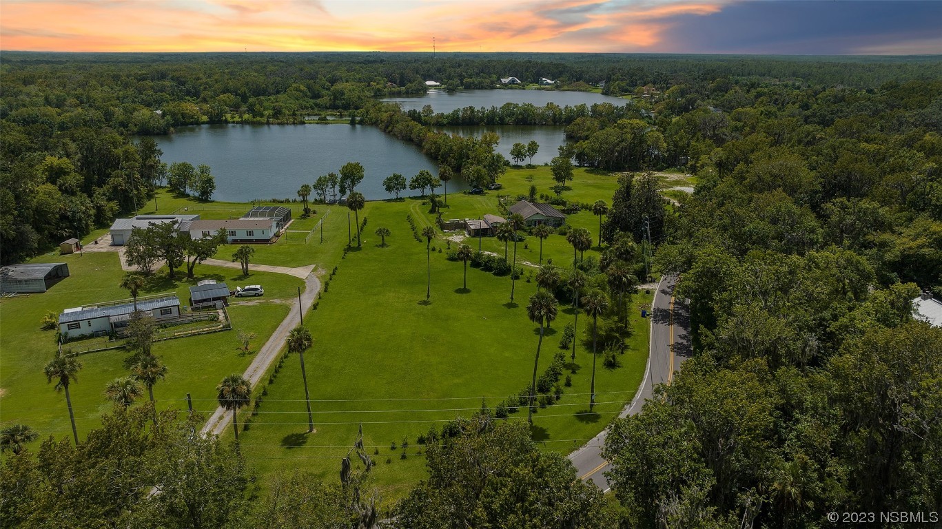 2422 South Taylor Road New Smyrna Beach, FL 32168 - Photo 3 of 19 a view of a lake with a house