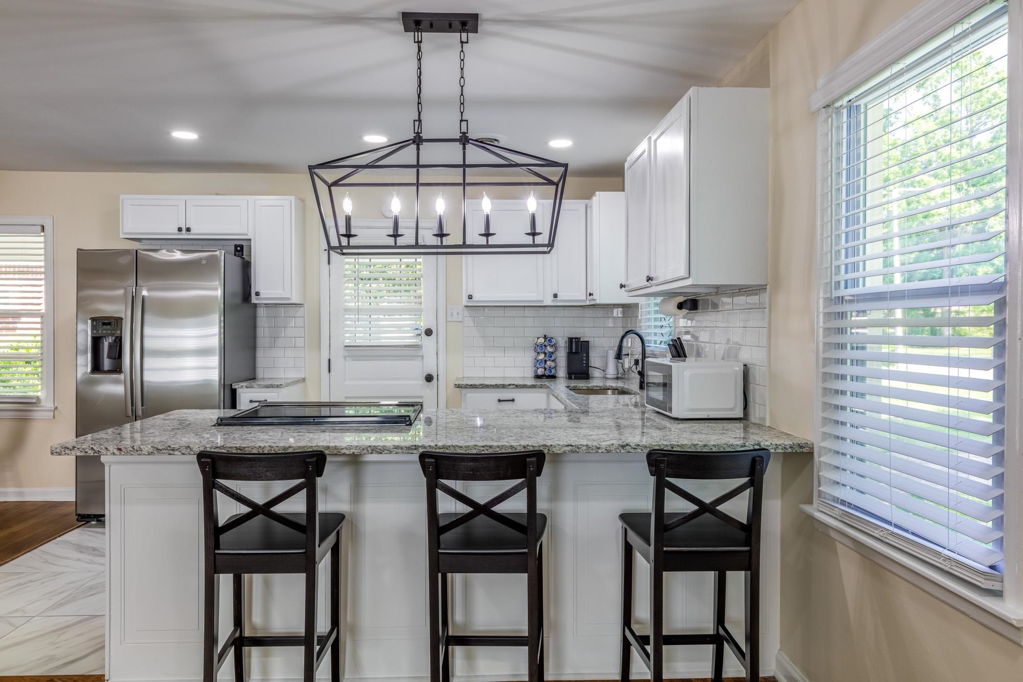 4620 Sea Isle Road Memphis, TN 38117 - Photo 7 of 14 a kitchen with stainless steel appliances granite countertop a sink a stove a refrigerator and island