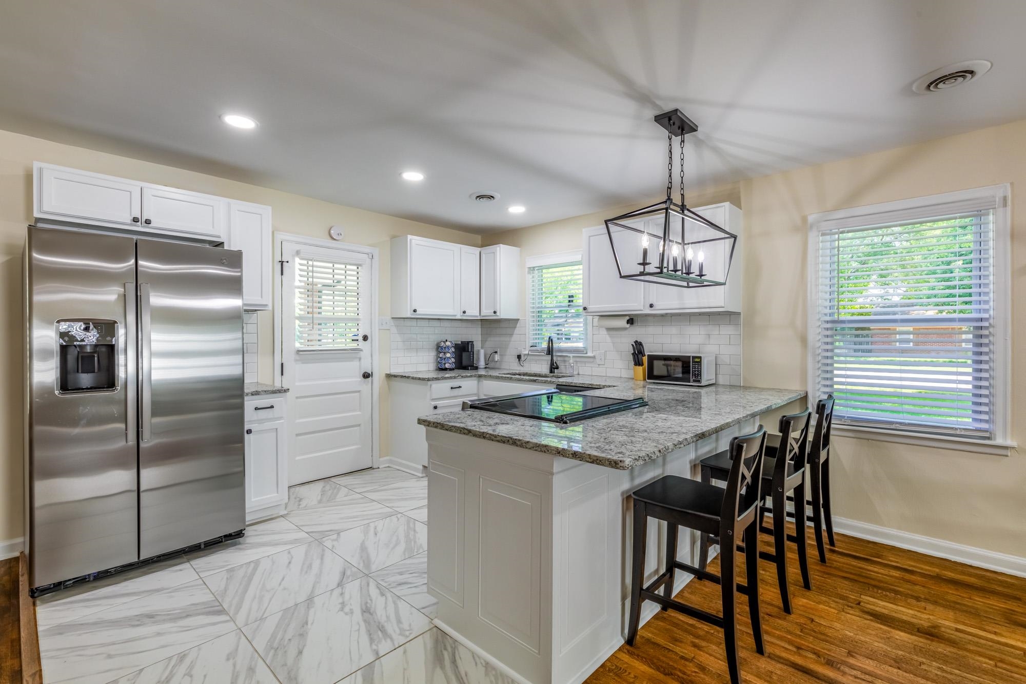 4620 Sea Isle Road Memphis, TN 38117 - Photo 8 of 14 a kitchen with stainless steel appliances granite countertop a sink a stove a refrigerator cabinets and a dining table