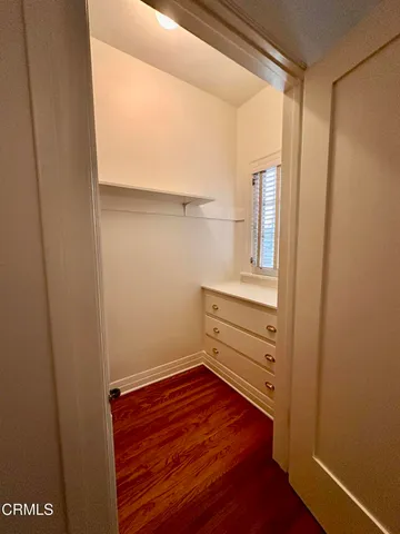 a view of a dresser with wooden floor
