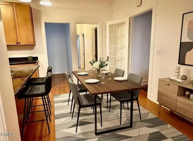 a view of a room with wooden floor and a ceiling fan