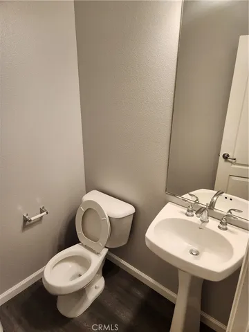 a white toilet sitting next to a bathroom sink