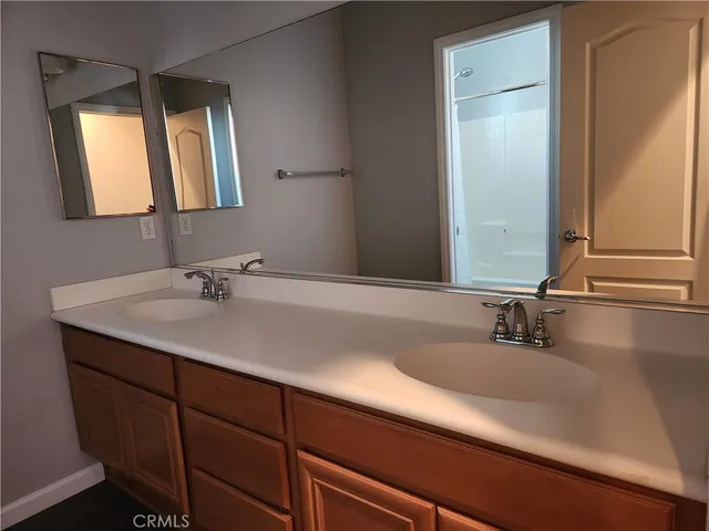a bathroom with a double vanity sink and a mirror