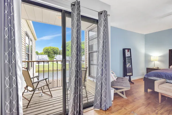 a living room with furniture and a floor to ceiling window
