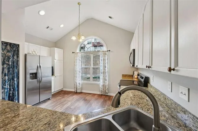 a view of a kitchen with a sink stainless steel appliances and cabinets