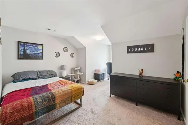 a bedroom with a bed and a desk