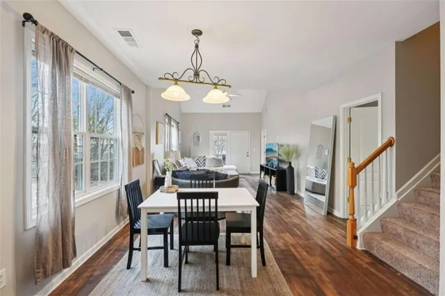 a view of a dining room with furniture window and wooden floor