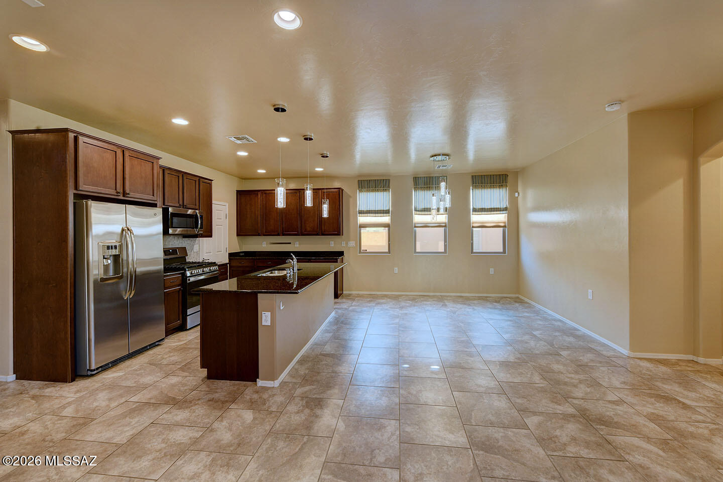 13991 East Cheavront Loop Vail, AZ 85641 - Photo 5 of 47 a large kitchen with stainless steel appliances kitchen island granite countertop a large counter top stainless steel appliances and cabinets