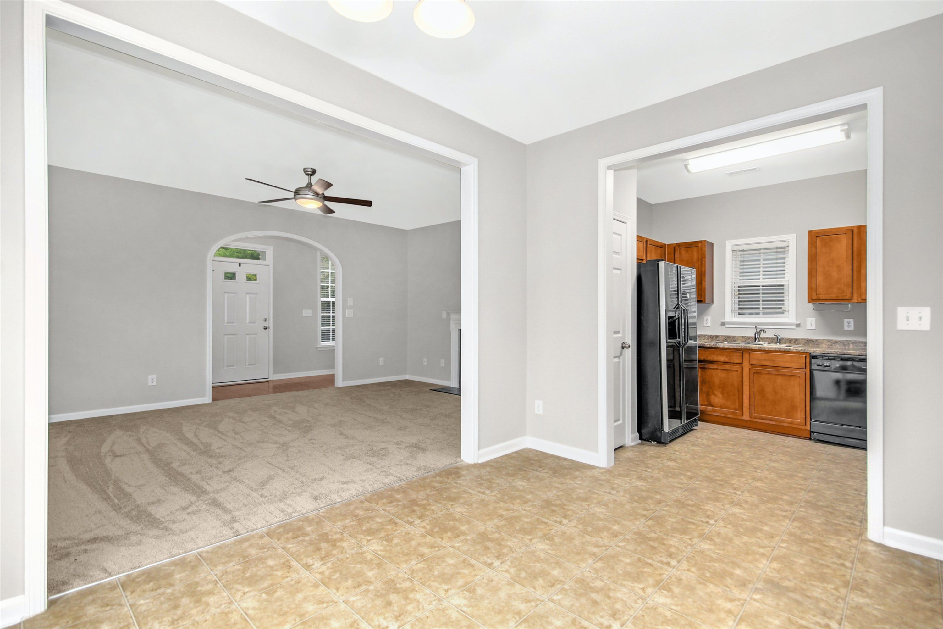175 Sioux Lane Clayton, NC 27520 - Photo 11 of 26 a view of a kitchen with a sink cabinet and a living room view
