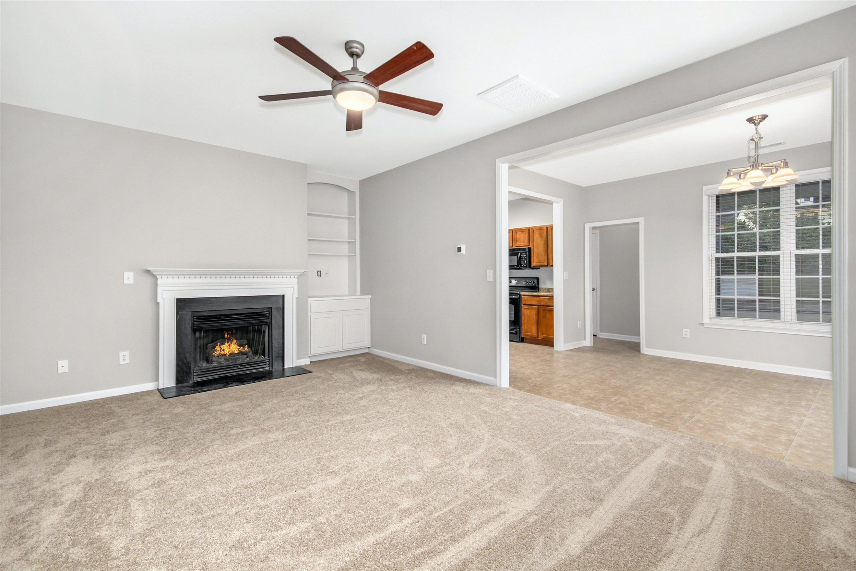 175 Sioux Lane Clayton, NC 27520 - Photo 7 of 26 an empty room with windows and fireplace