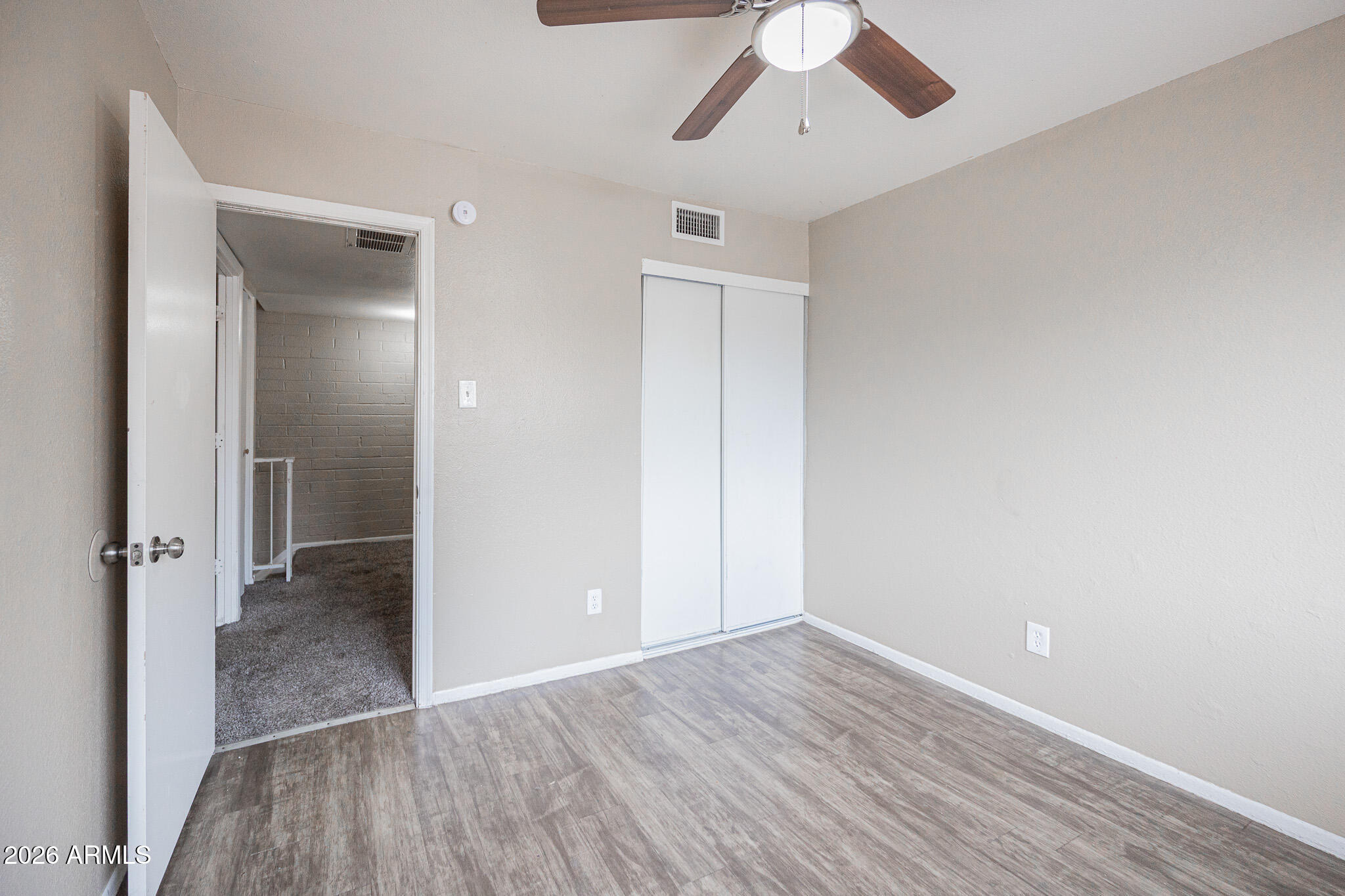 5041 North 39th Lane Phoenix, AZ 85019 - Photo 13 of 15 wooden floor in an empty room