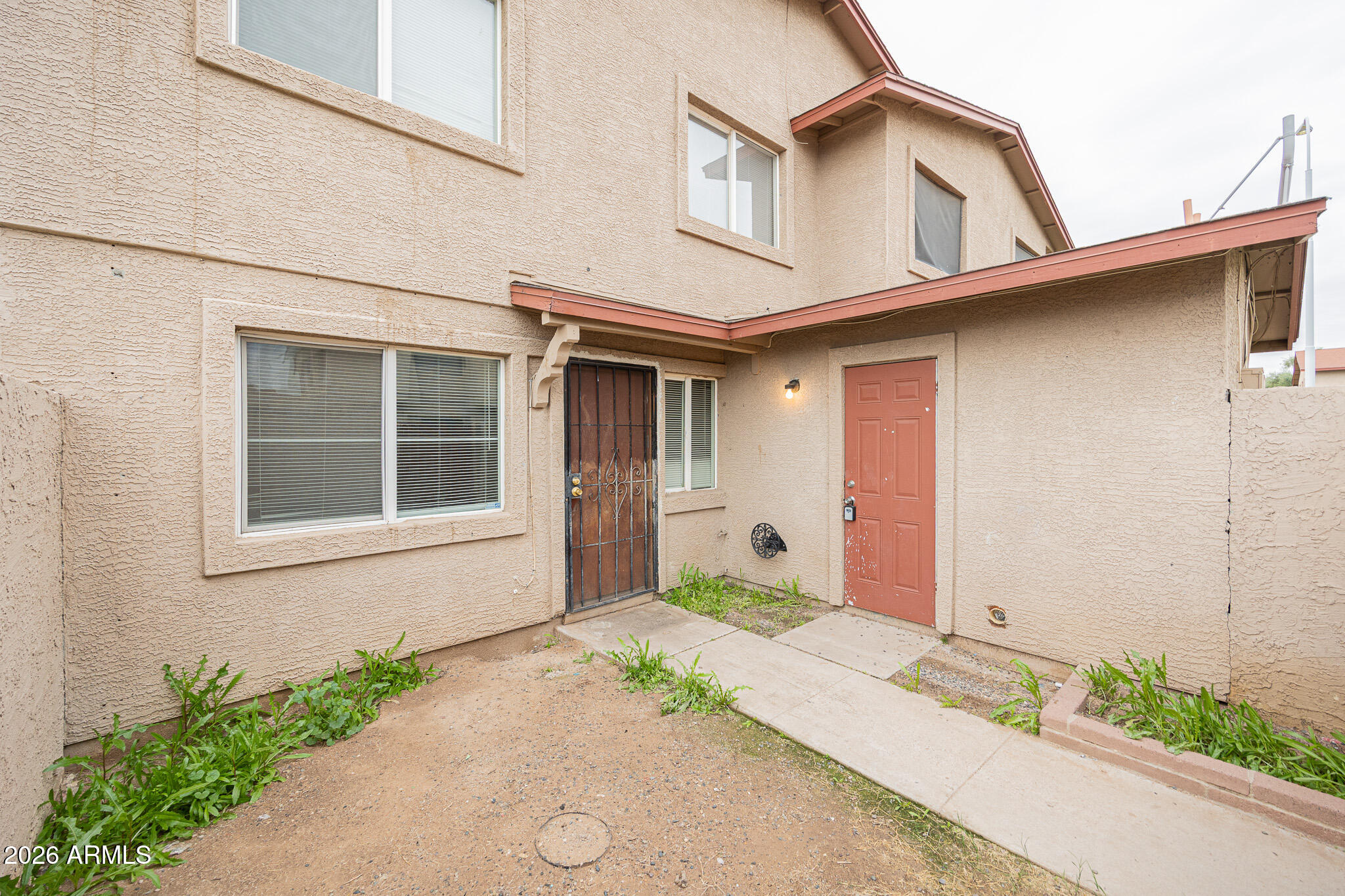 5041 North 39th Lane Phoenix, AZ 85019 - Photo 15 of 15 a front view of a house with a yard and garage