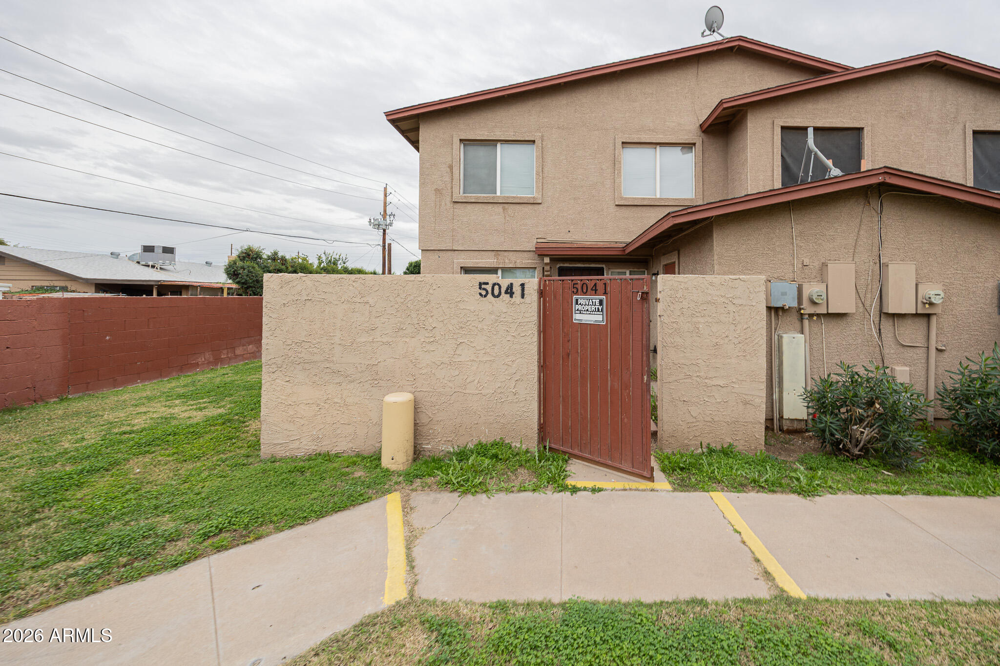 5041 North 39th Lane Phoenix, AZ 85019 - Photo 2 of 15 a view of a house with a yard