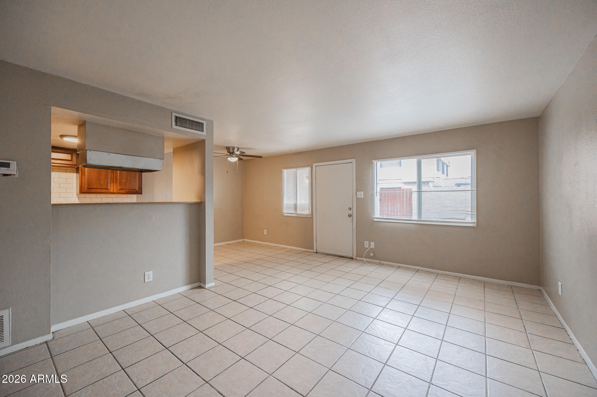 5041 North 39th Lane Phoenix, AZ 85019 - Photo 5 of 15 a view of an empty room with window