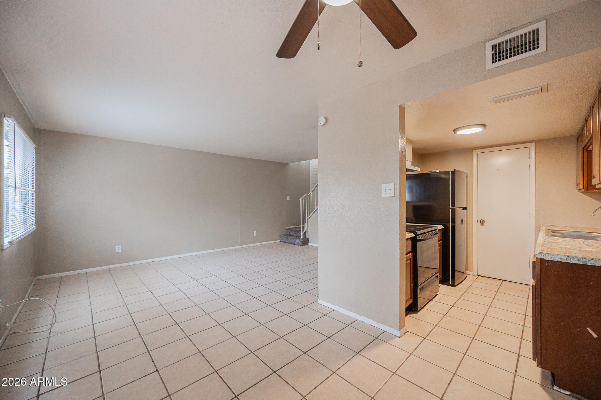 5041 North 39th Lane Phoenix, AZ 85019 - Photo 7 of 15 a view of a kitchen with microwave and refrigerator