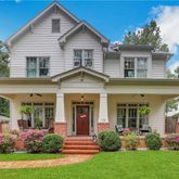 a front view of a house with a yard and porch