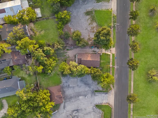 an aerial view of a house with a yard