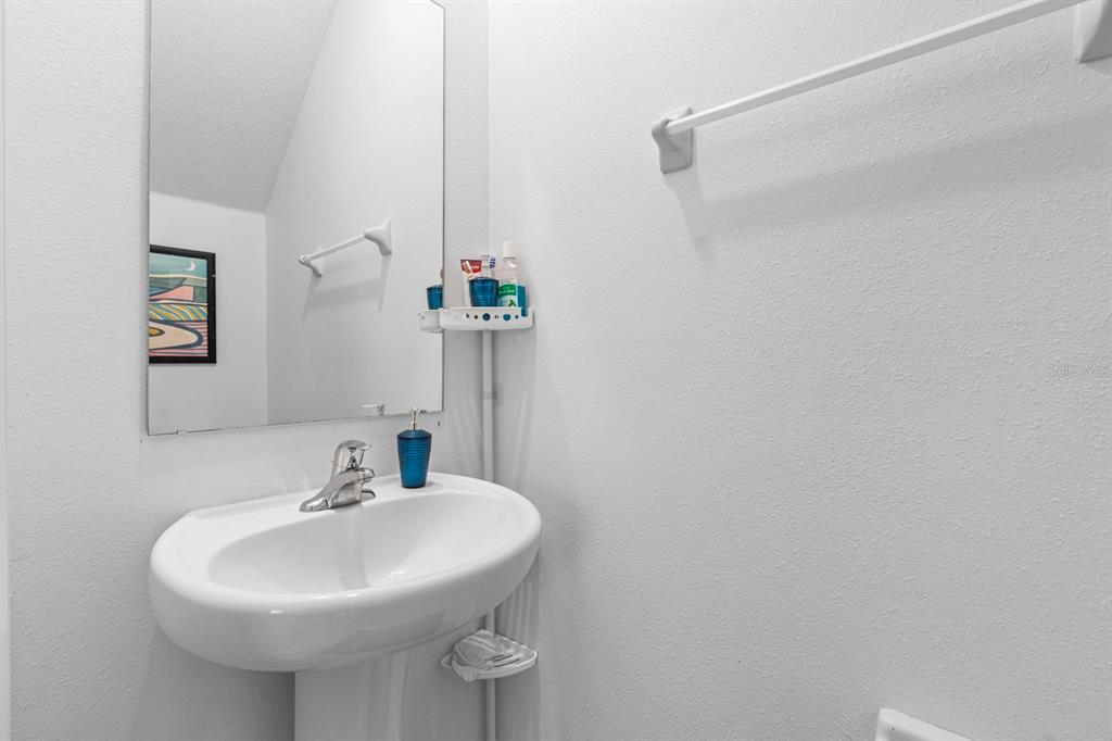 36498 Camp Fire Terrace Zephyrhills, FL 33541 - Photo 16 of 38 a bathroom with a sink and a mirror