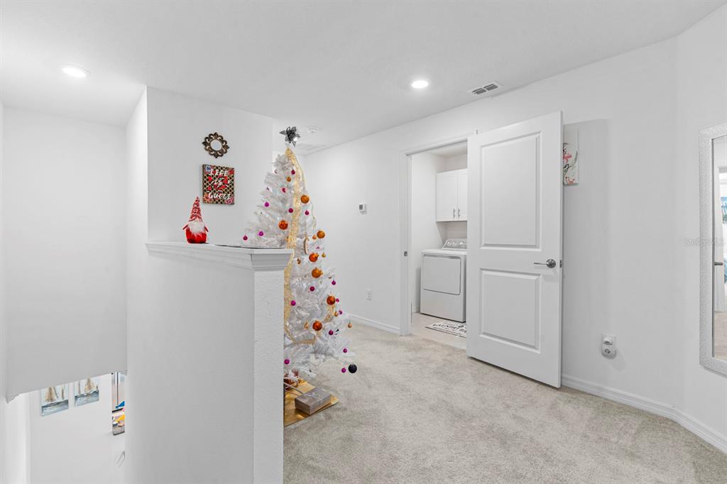 36498 Camp Fire Terrace Zephyrhills, FL 33541 - Photo 22 of 38 a room with white cabinets and window