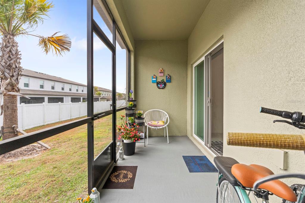 36498 Camp Fire Terrace Zephyrhills, FL 33541 - Photo 29 of 38 a living room with furniture and a floor to ceiling window