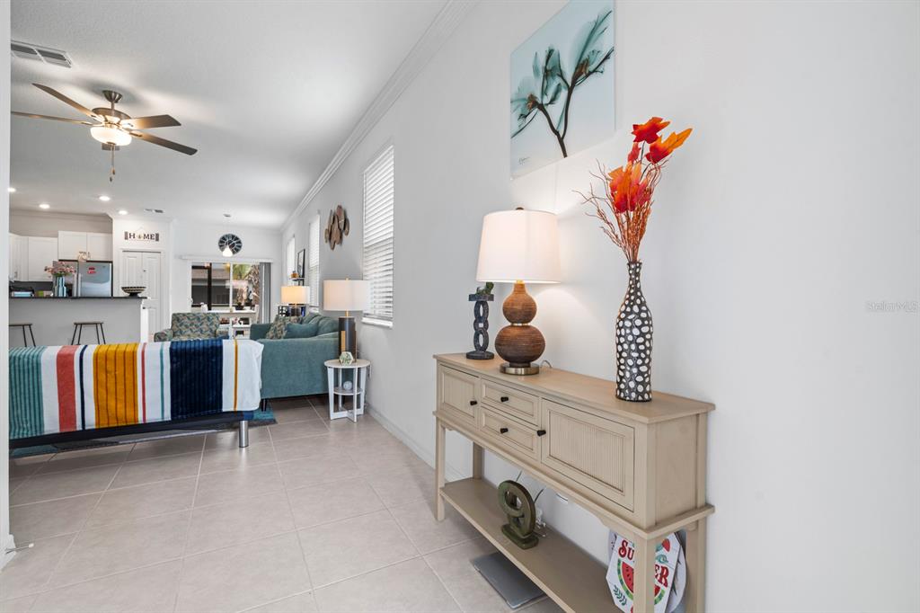 36498 Camp Fire Terrace Zephyrhills, FL 33541 - Photo 6 of 38 a living room with furniture and a flat screen tv