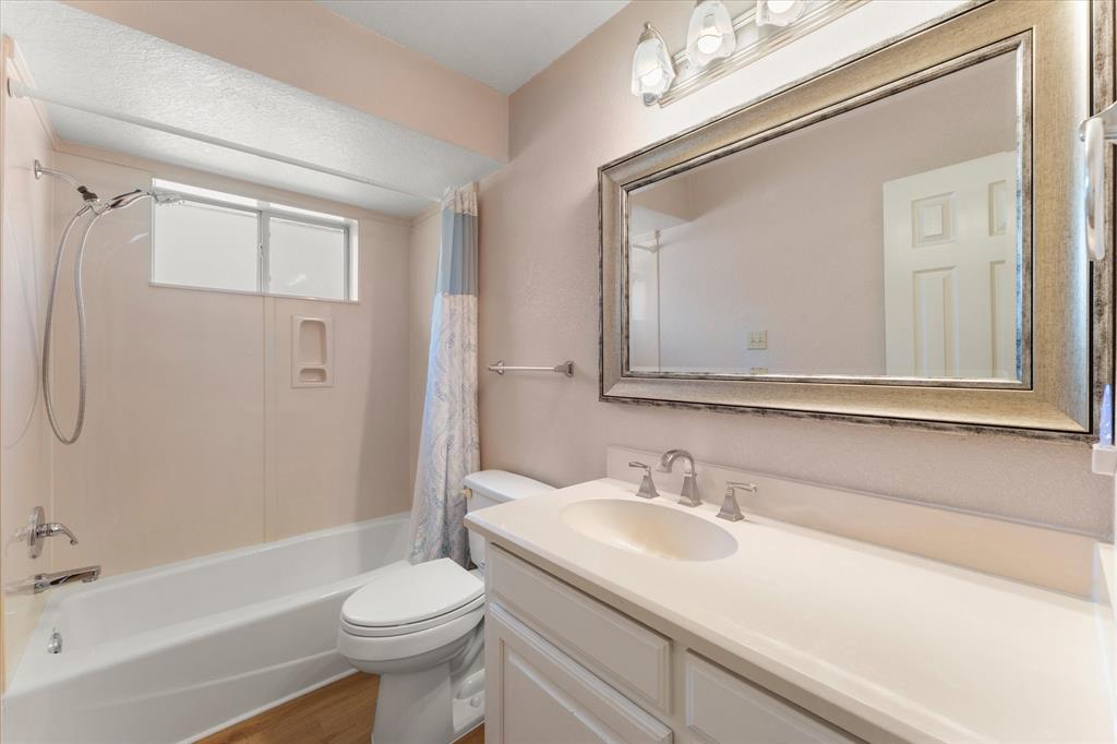 116 Meadowood Road Enchanted Oaks, TX 75156 - Photo 25 of 37 Bathroom featuring a single vanity with an integrated sink, polished chrome faucet, and a large framed mirror