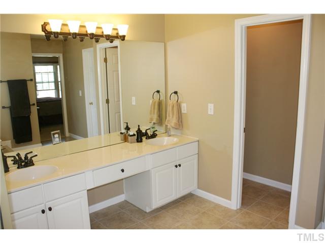 8508 Wheeling Drive Raleigh, NC 27615 - Photo 4 of 12 Spacious master bathroom has dual vanity, shower, large walk-in closet and garden tub. Brand new tile flooring, lighting and fixtures.
