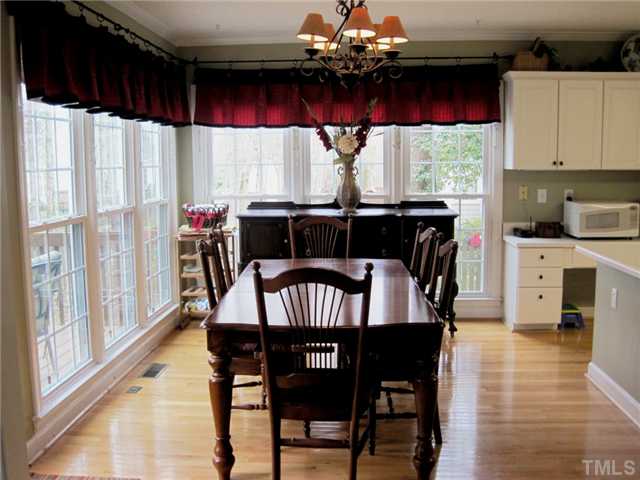 8508 Wheeling Drive Raleigh, NC 27615 - Photo 10 of 12 Huge breakfast nook with two walls of windows. Hardwood floors throughout kitchen. Very open floor plan is great for entertaining.