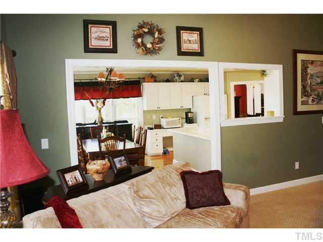 8508 Wheeling Drive Raleigh, NC 27615 - Photo 11 of 12 Open floor plan with a view of the two-story family room to the kitchen.