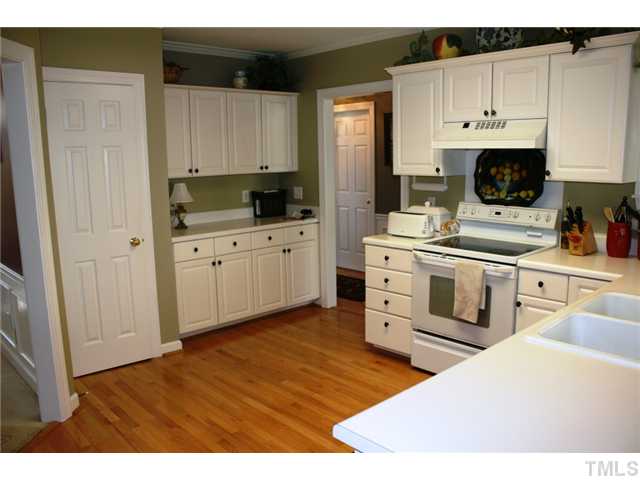 8508 Wheeling Drive Raleigh, NC 27615 - Photo 7 of 12 Large kitchen with hardwood floors overlook the backyard.