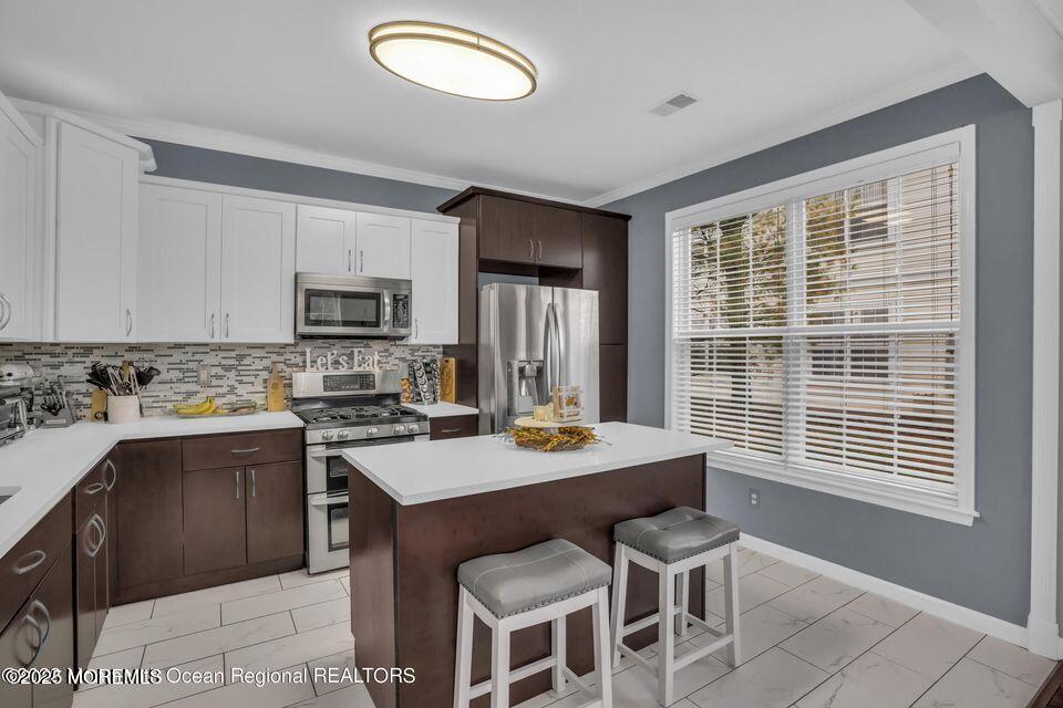 410 St Andrews Place Manalapan, NJ 07726 - Photo 11 of 23 a view of a kitchen counter space and a window