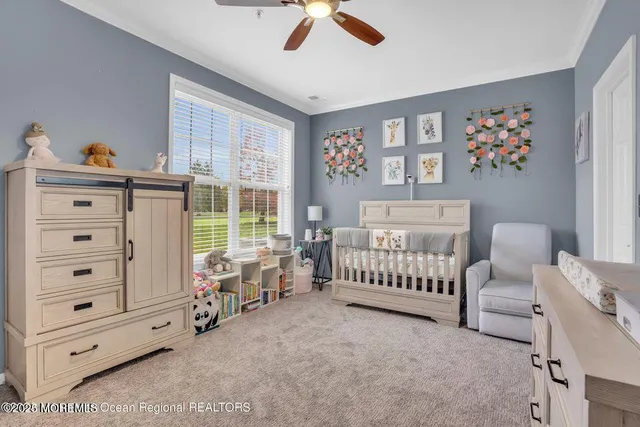 a bedroom with furniture and a large window