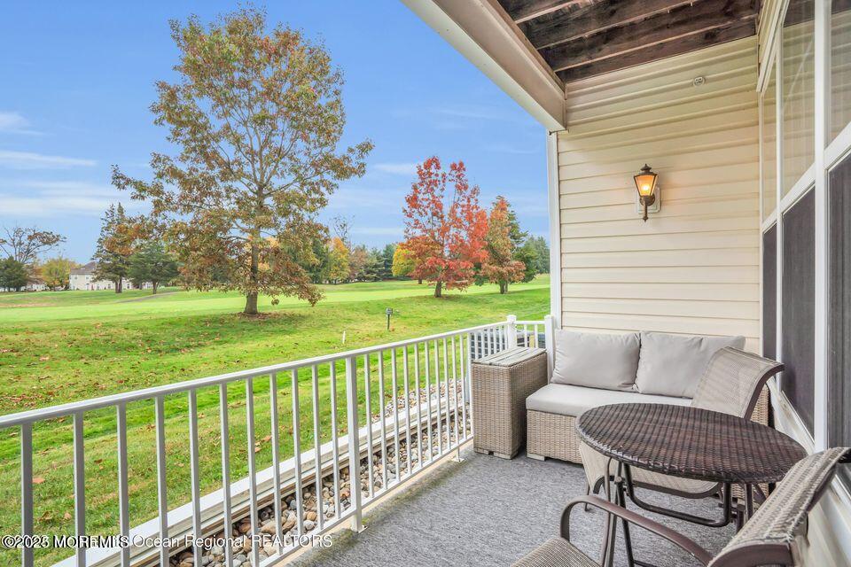 410 St Andrews Place Manalapan, NJ 07726 - Photo 20 of 23 a view of a porch with furniture and a yard