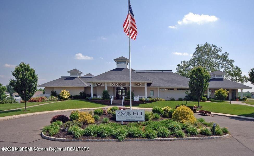 410 St Andrews Place Manalapan, NJ 07726 - Photo 22 of 23 a front view of a house with a yard and potted plants