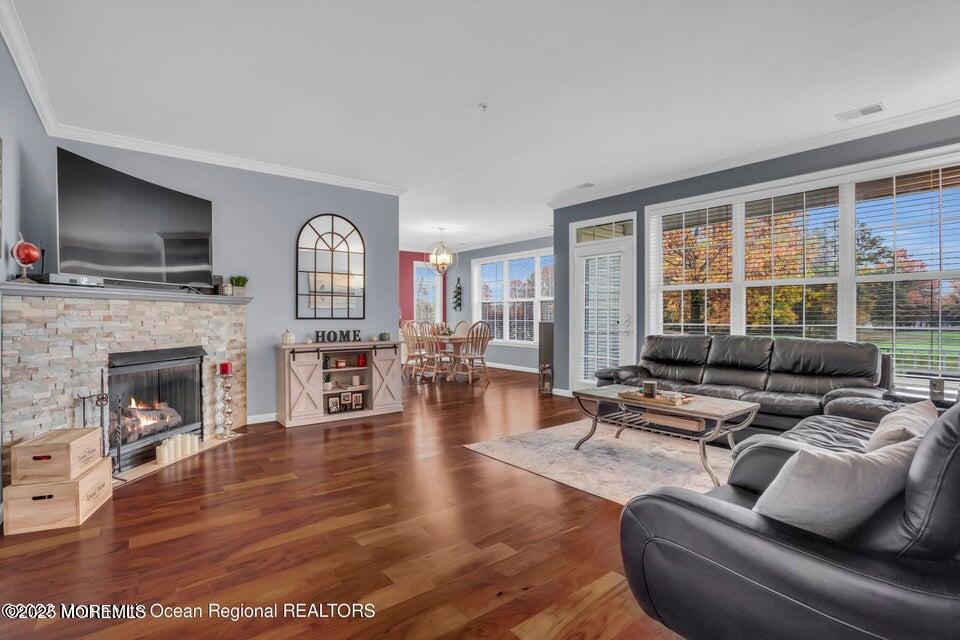 410 St Andrews Place Manalapan, NJ 07726 - Photo 4 of 23 a living room with furniture fireplace and a flat screen tv