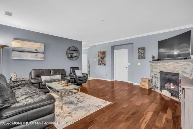a living room with fireplace furniture and a flat screen tv