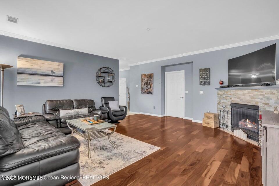 410 St Andrews Place Manalapan, NJ 07726 - Photo 5 of 23 a living room with fireplace furniture and a flat screen tv