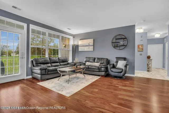 a living room with furniture and large window